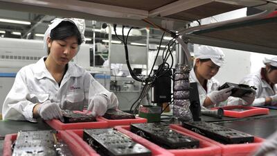Workers inspect motherboards on a factory line at the Foxconn plant in Shenzen. The Taiwanese company, which manufactures Apple’s iPhone in China, revealed plans to create 10 to 12 factories and up to 1 million jobs in India by 2020. Voishmel / AFP