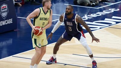 LeBron James of USA, right, takes on Jock Landale of Australia.