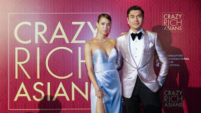 Actor Henry Golding and his wife Liv Lo pose as they arrive for the red carpet. Don Wong / AP photo