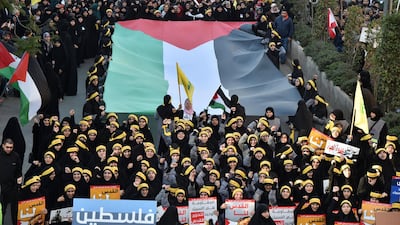 Supporters of Hezbollah carry national, Palestinian and Hezbollah flags during a protest in south Beirut against US President Donald Trump's decision to recognize Jerusalem as the capital of Israel. Wael Hamzeh / EPA