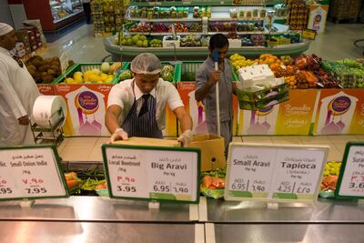 A supermarket worker stocks up goods in Lulu in Umm Al Quwain. Antonie Robertson / The National