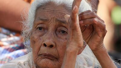 A elderly woman sits at a refugee camp after an earthquake hit Sigar Penjalin village in North Lombok, Indonesia. Reuters