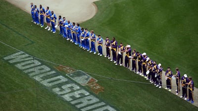 Sachin’s Blaster (in blue) and Warne’s Warriors (purple) players line up during the US national anthem at Citi Field, where baseball’s World Series concluded on last weekend. Jewel Samad / AFP