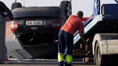 A man starts to tow away the car involved in a terrorist attack in Cambrils,. Lluis Gene / AFP Photo