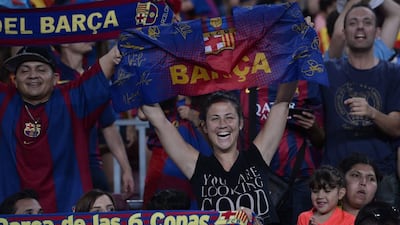 A fan of FC Barcelona brandishes a flag during the celebrations held for their victory over Juventus, one day after the UEFA Champions League final football, at the Camp Nou stadium in Barcelona on June 7, 2015. Luis Suarez and Neymar scored second-half goals to give Barcelona a 3-1 Champions League final victory over Juventus on June 6, 2015 as the Spaniards became the first team to twice win the European treble. AFP PHOTO/ JOSEP LAGO