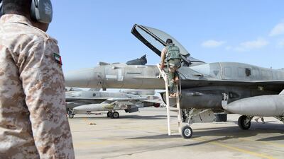 A handout image made available on February 12, 2015 by the UAE news agency, Wam, shows pilots of the UAE armed forces next to F16 aircraft. AFP