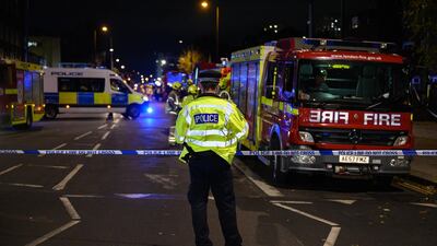 Police officers secure the cordon around Edmonton Green police station. Getty Images