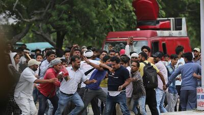 Supporters of the Dera Sacha Sauda sect attack a member of the media covering the rape trial. Altaf Qadri / AP Photo