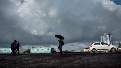 Monsoon clouds fill the sky as residents in India's Kerala state seek shelter form the rain.