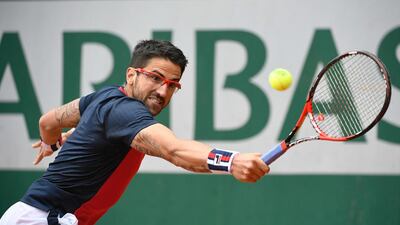 Serbia’s Janko Tipsarevic returns the ball to Canada’s Milos Raonic during their men’s first round match at the Roland Garros 2016 French Tennis Open in Paris on May 23, 2016. Martin Bureau / AFP