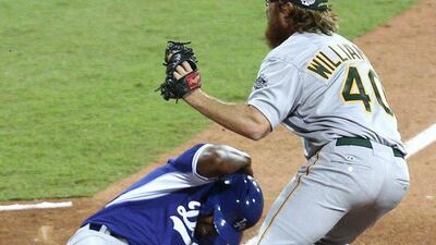 Australia Baseball's Matt Williams covers home plate as Los Angeles Dodgers infielder Chone Figgins slides during an exhibition between the Dodgers and Team Australia on Thursday at Sydney Cricket Ground. Rick Rycroft / AP / March 20, 2014