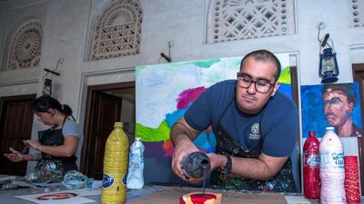 Abdullah Lutfi, who has autism, paints at Mawaheb, an art studio in Dubai’s Al Fadi neighbourhood. Victor Besa for The National
