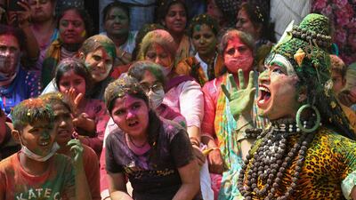 An artist dressed as Hindu god Shiva, right, performs at a temple as a part of Holi celebrations which is a popular Hindu spring festival of colours in Amritsar. AFP