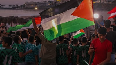 Lebanese lift Palestinian flags during a solidarity vigil in Beirut. AFP