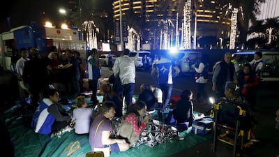 Wounded people are seen outside the Address Downtown Dubai hotel and residential block after a fire engulfed the skyscraper in downtown Dubai. Ahmed Jadallah / Reuters