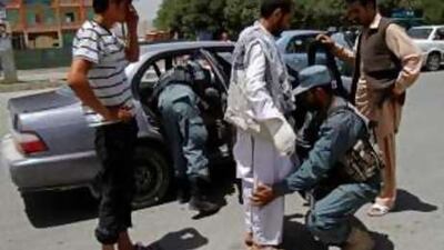 Policemen check vehicles and commuters in Kabul yesterday.