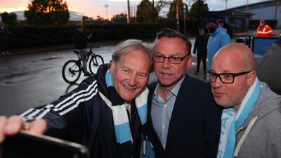 Manchester City fans celebrate with former player Paul Dickov at the Etihad Stadium. PA