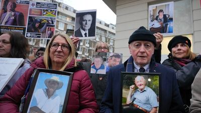 Protesters with pictures of Covid victims outside Dorland House as Britain's former prime minister Boris Johnson testifies at Britain's Covid-19 public inquiry in London. AP