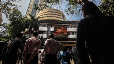 People watch a screen displaying the budget news near the entrance of the Bombay Stock Exchange in Mumbai. EPA