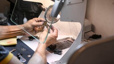 Harihar Mondal, a skilled craftsman from West Bengal, uses a mini magnifier to focus on details while polishing a piece at the studio in Mussafah, Abu Dhabi.