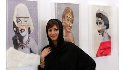 The artist Leila al Marashi stands next to Marilyn, Beyoncé and Britain's Elizabeth II. The pieces use hundreds of pearls and crystals. Satish Kumar / The National