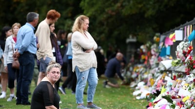Locals continue to leave messages and flowers for the victims outside the Botanic Gardens on March 16, 2019 in Christchurch, New Zealand after at least 49 people are confirmed dead, with more than 40 people injured following attacks on two mosques in Christchurch on Friday afternoon. Photo: Getty