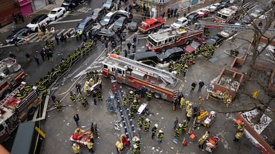 Firefighters work outside an apartment building after a fire in the Bronx, Sunday, Jan. 9, 2022, in New York. (AP Photo / Yuki Iwamura)