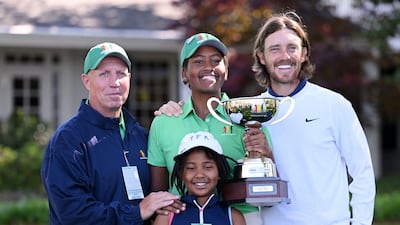Maya Gaudin poses with the trophy with her father Steve Gaudin, her sister Willa Gaudin, and Tommy Fleetwood after winning the Drive, Chip and Putt Championship at Augusta National Golf Club. Getty