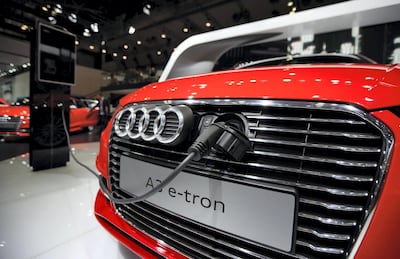 A charging cable is connected to the front grill of an Audi AG A3 e-tron electric vehicle at the 43rd Tokyo Motor Show 2013 in Tokyo, Japan. Bloomberg