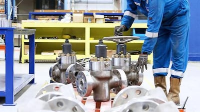 A worker checks valves and manifolds being manufactured at Weir Group's plant at Jebel Ali. Pawan Singh / The National