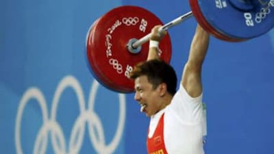 Zhang Xiangxiang of China powers his way through a 169kg lift.