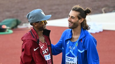 Mutaz Barshim speaks to Gianmarco Tamberi after the men's high jump final at the World Athletics Championships. AFP