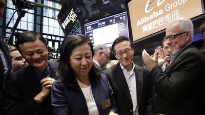 Chief financial officer of Alibaba Maggie Wu strikes a bell as Jack Ma, left, founder of Alibaba, watches during the company’s IPO at the New York Stock Exchange. Mark Lennihan / AP Photo