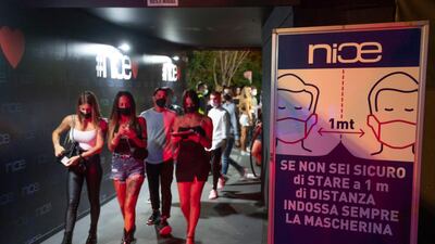 Signs remind people to maintain social distancing at a disco in Rome, Italy, on August 15, 2020. EPA