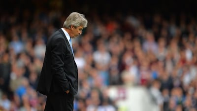 Manchester City manager Manuel Pellegrini walks on the touchline during the English Premier League match against West Ham United at Upton Park in London on October 25, 2014. Glyn Kirk / AFP