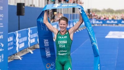 Henri Schoeman raises the finishing tape after winning the ITU World Triathlon Abu Dhabi. Reem Mohammed / The National