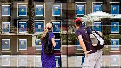 Customers browse the selection of property ads posted at the Better Homes office in Dubai. Lauren Lancaster / The National