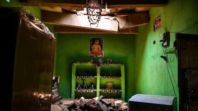 Bricks from the ceiling are seen on the bed of 24 year old Sunil Kumar, who died after getting crushed. Chandan Khanna / AFP