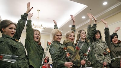 Russia-backed female rebel fighters wave while posing for media after a beauty contest involving women from the main separatist battalions in Donetsk, Ukraine on March 7. Vadim Ghirda / AP Photo