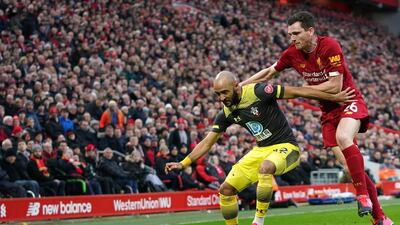 Liverpool's Andrew Robertson, right, challenges Southampton's Nathan Redmond at Anfield on Saturday. AP