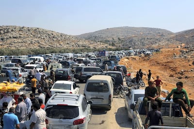 Cars and trucks line up to enter Turkey from Syria as hundreds of protesters gather during a demonstration at the Bab Al Hawa border crossing. AP