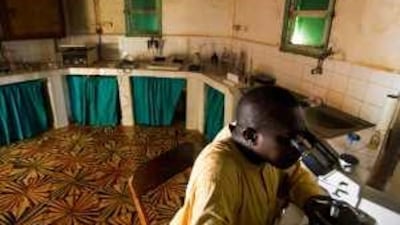 Emile Niang at work in the laboratory of the medical centre in Fatick, Senegal.