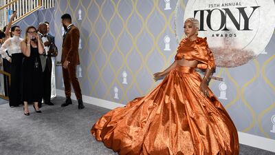 US actress Kara Young in an orange crop top and ball skirt. Invision / AP
