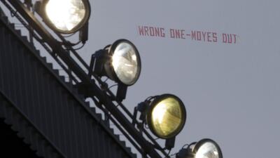 A banner critical of manager David Moyes is flown above Old Trafford Stadium during Manchester United’s English Premier League soccer match against Aston Villa, in Manchester, England on Saturday March 29, 2014. AP Photo/Jon Super