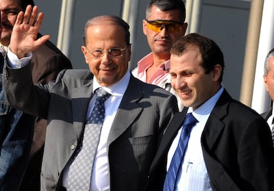 Michel Aoun (L) waves as he leaves Beirut International Airport with son-in-law Gebran Bassil on May 16, 2008 on his way to a meeting in Doha. AFP