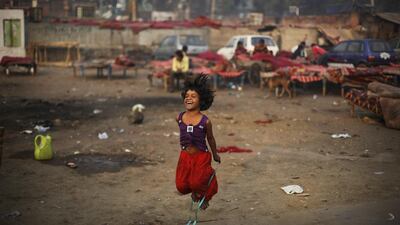 An economically underprivileged girl plays next to a makeshift shelter in New Delhi, India. Some 800 million people in the country live in poverty, many of them migrating to big cities in search of a livelihood and often ending up on the streets. Altaf Qadri / AP Photo