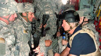 U.S. Senator and Democratic presidential candidate Joe Biden talks with soldiers as he travels in a military vehicle to Iraq from Kuwait in this September 6, 2007. Reuters