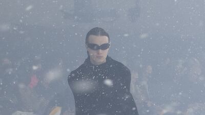 A model wraps himself in a towel.