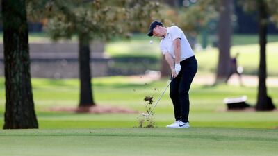 Rory McIlroy chips on the second hole. The Northern Irishman was unable to compete his first round due to the three-hour weather delay. AP