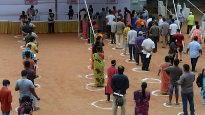 Circles on the ground delimit physical distancing as people wait to register for a special vaccination programme against Covid-19 at a government school in Hyderabad. AFP